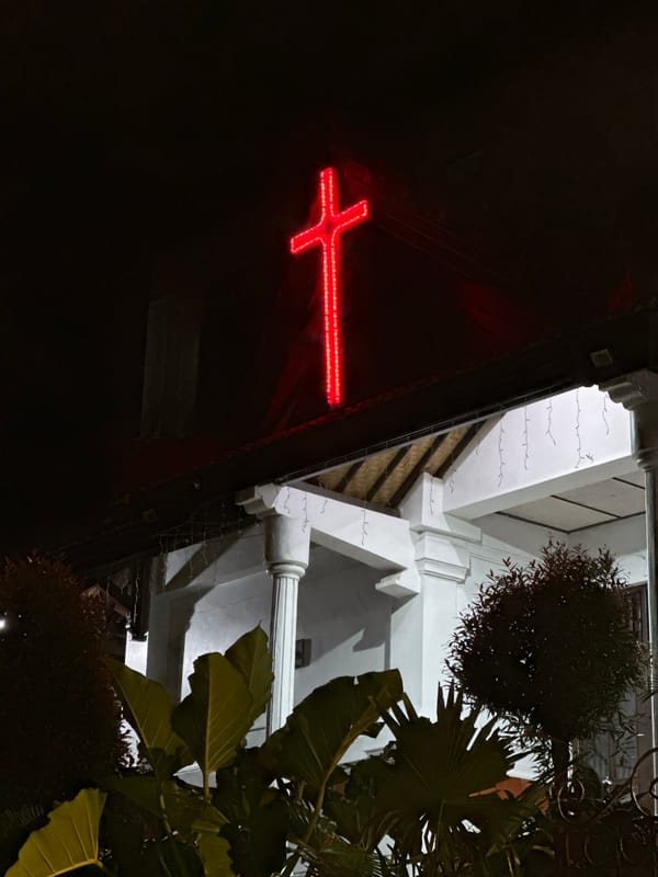 Red neon cross spotted on building in Ubud District