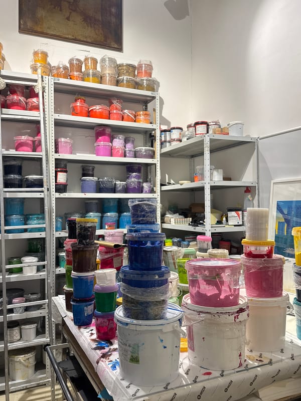 Storage room filled with colorful paint buckets documented