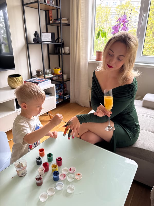 Mother and child share painting and manicure time in Riga apartment