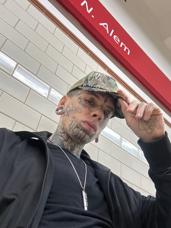 Tattooed Individual Photographed in Low-Angle Selfie in Buenos Aires