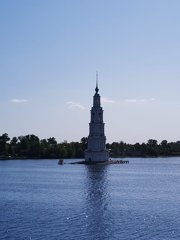Tourist documents historic flooded bell tower from barge in Russia