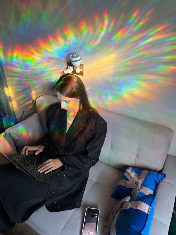 Relaxed evening on a couch, rainbow projector lighting the room