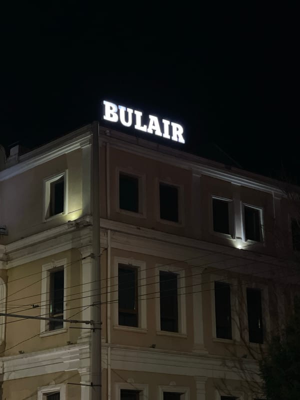 Illuminated building with BULAIR sign observed at night in Burgas