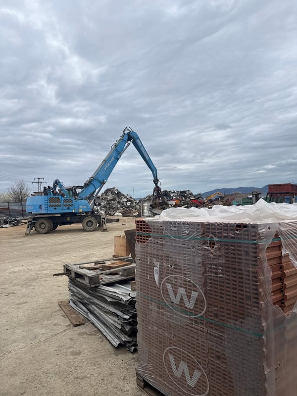 Industrial crane operates in Bulgarian scrapyard facility