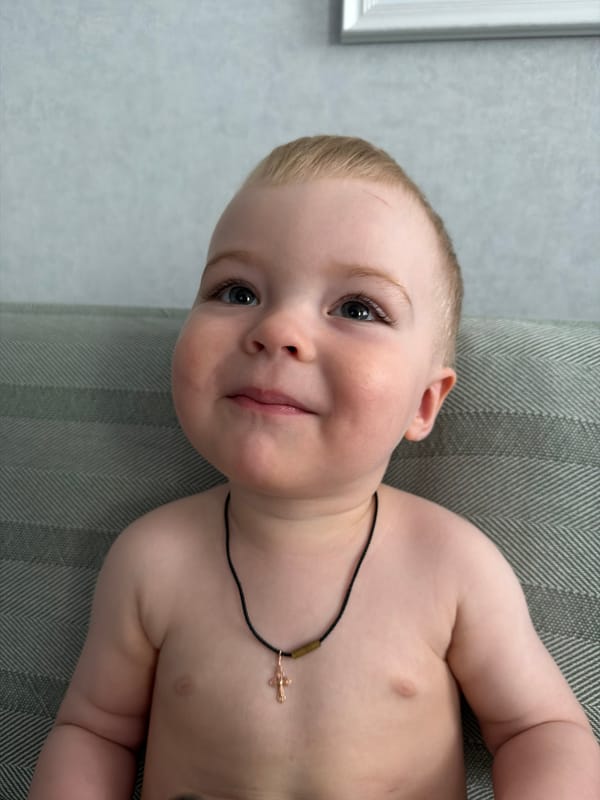 Toddler photographed on cushioned furniture in Votkinsk home
