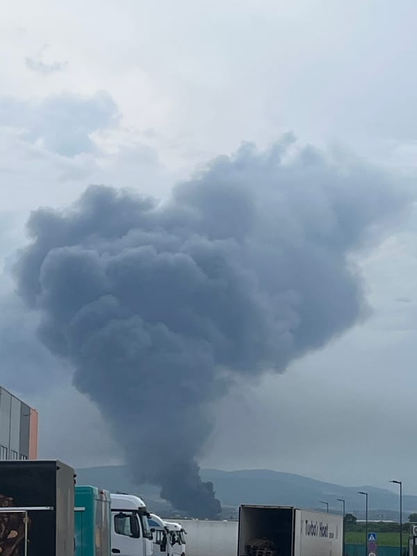 Heavy smoke plume rises over mountains from unknown fire source