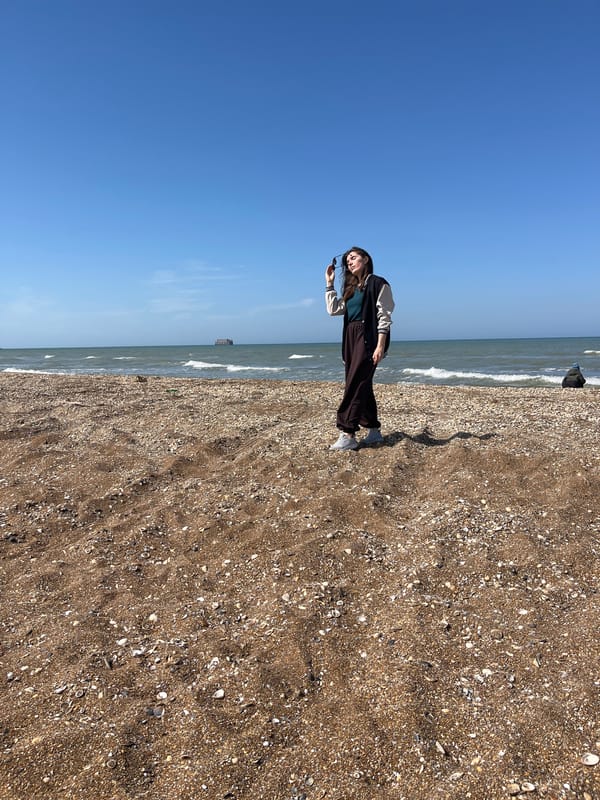 Woman stands on beach in Kaspiysk, Russia