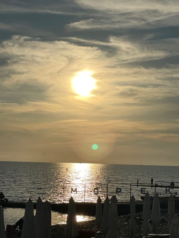 Sunset evening at Sochi beach with promenade and seaside dining
