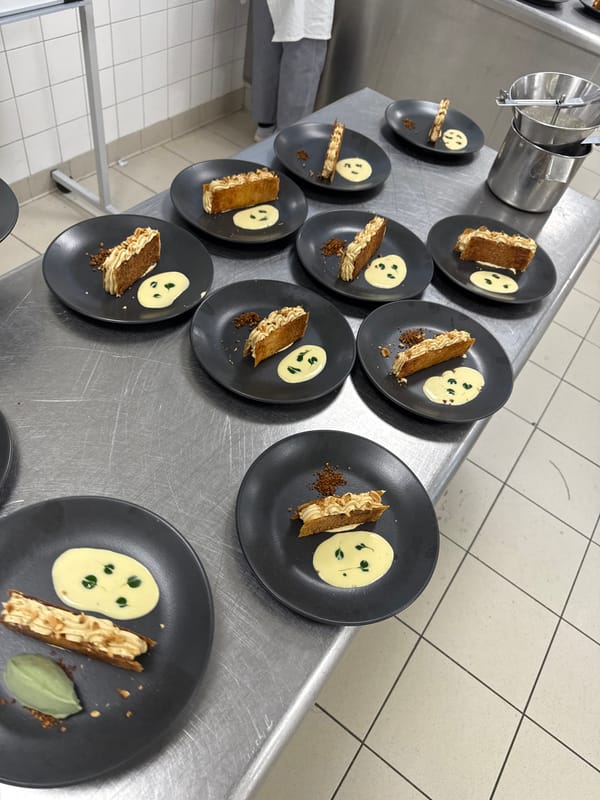 Chef prepares multiple plated dishes in Schiltigheim kitchen