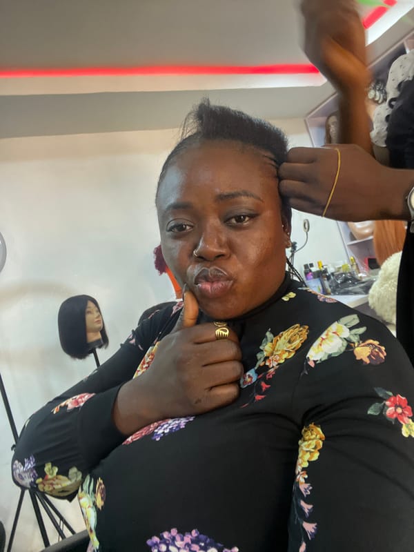 Hair braiding session documented at Abuja salon