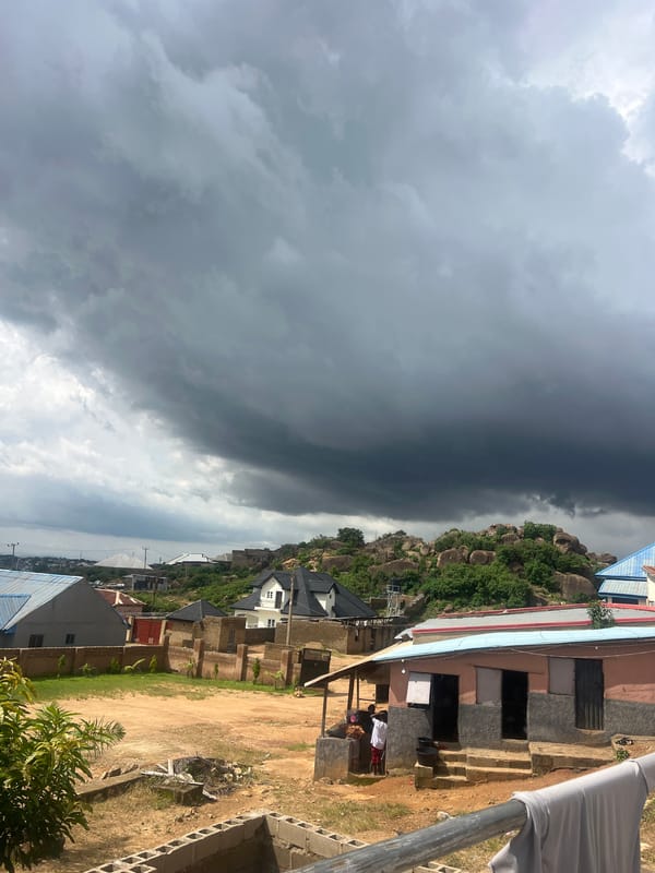 Traditional and modern buildings under storm skies in Jos, Nigeria