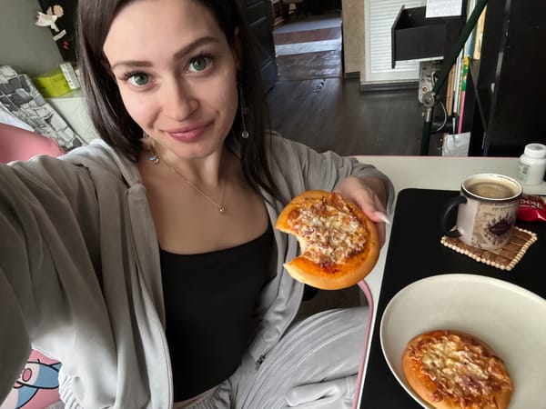Woman takes selfie while eating pizza in Reutov