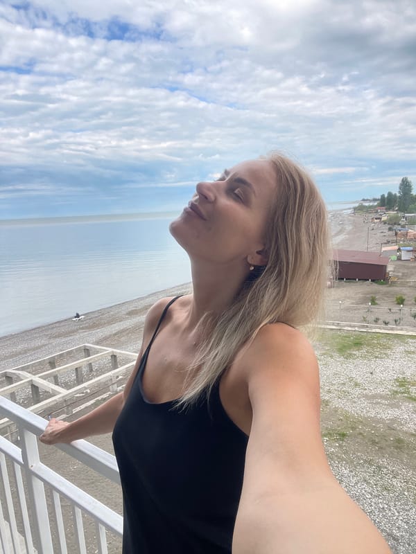 Woman enjoys early morning Black Sea views from Abkhazia balcony