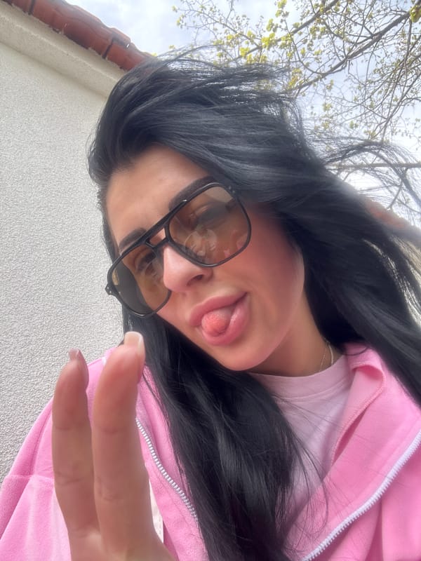 Woman takes playful selfie in pink jacket in Bulgaria