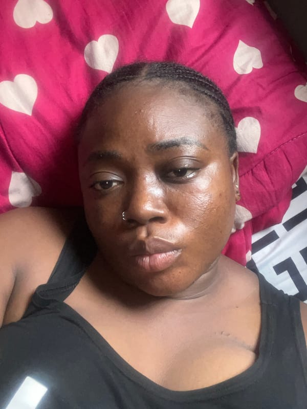 Woman photographs herself in bedroom with stuffed animal, Abuja
