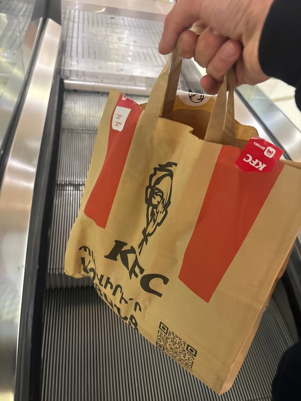 Person carries KFC bag on escalator in Yerevan