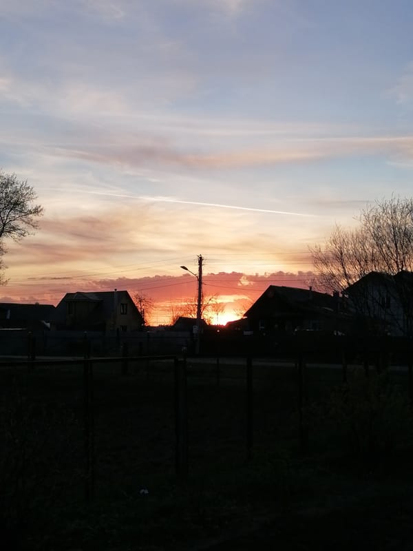 Sunset observed over residential area with orange-red sky