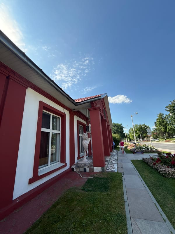 Red-and-white Moscow building with rose gardens and outdoor dining