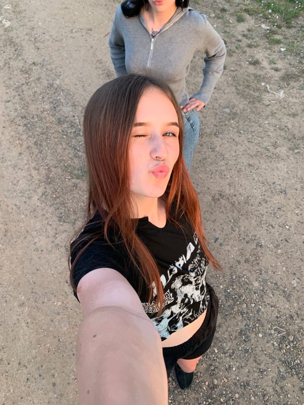 Young women take sunset selfies in Фоки, Russia