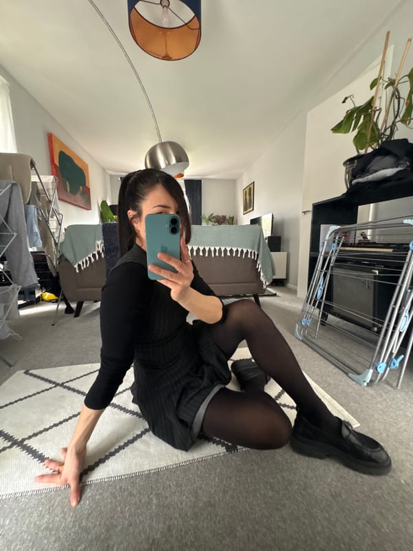 Woman takes indoor selfies in London wearing striped outfit