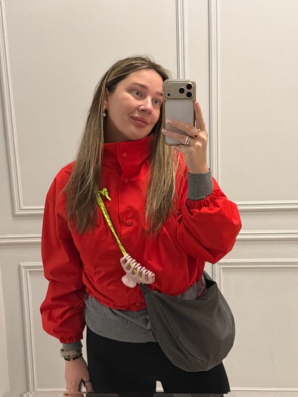 Woman takes morning selfies in red jacket, Moscow