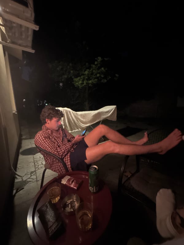 Late night in a Belgrade courtyard, drinks and cigarettes