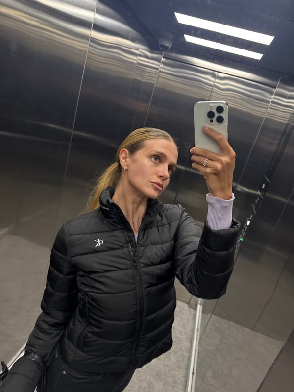 Woman Takes Elevator Selfie with iPhone in CK Jacket