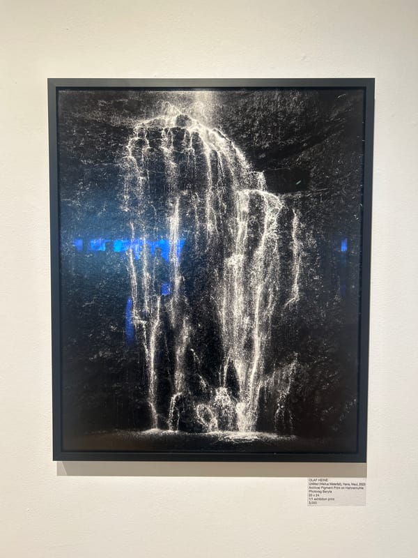 Late-night art viewing of water cascade photograph in West Hollywood