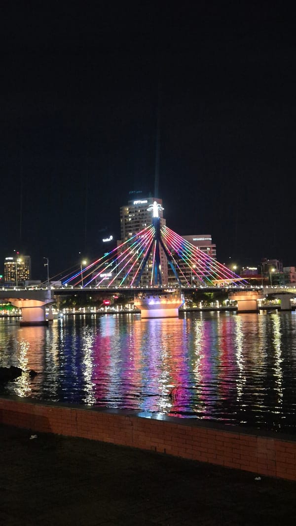 Dragon Bridge glows with multicolored lights over the Hàn River