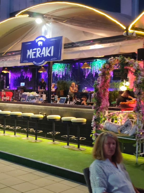 Nesebar nightlife: bars, neon, parked cars, and ice cream