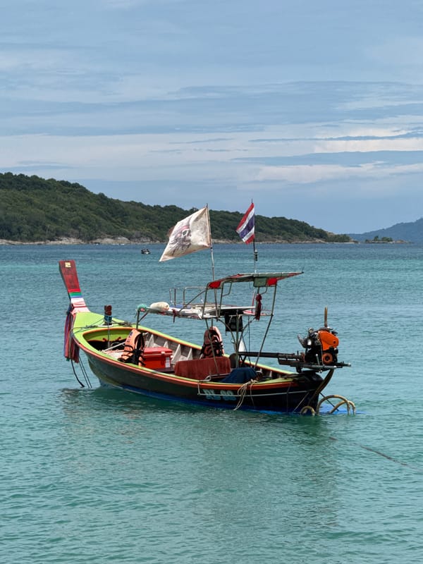 Longtail boats at rest in calm waters off Rawai