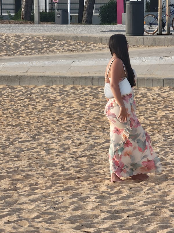 Barefoot stroll on Quarteira beach at hazy sunset