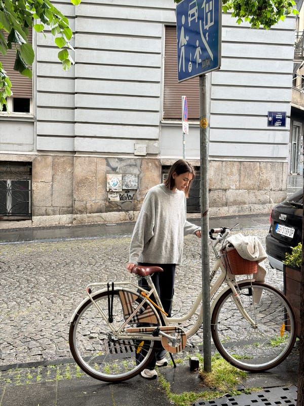 Woman with bicycle spotted on Belgrade cobblestone street