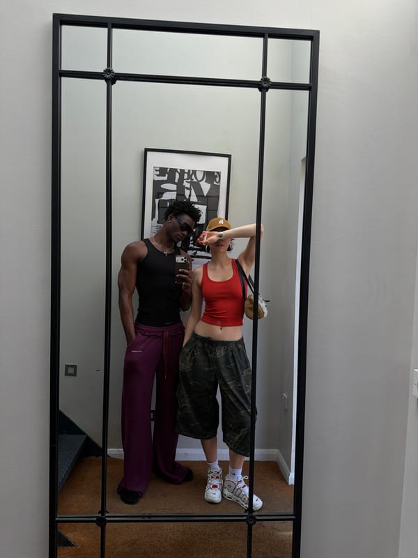 Couple reflected in gridded mirror captured in London