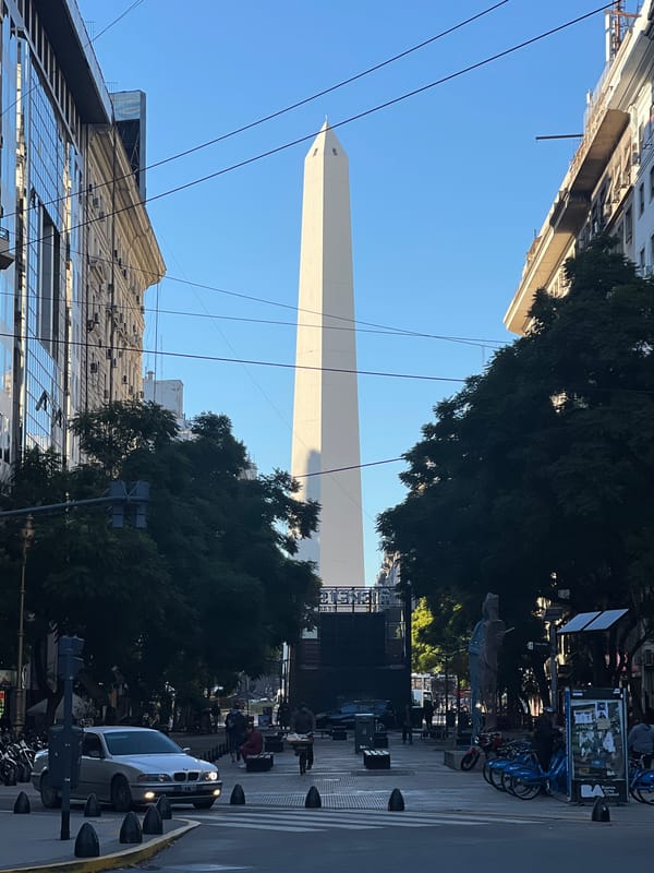 Tourist documents Buenos Aires landmarks during midday walking tour