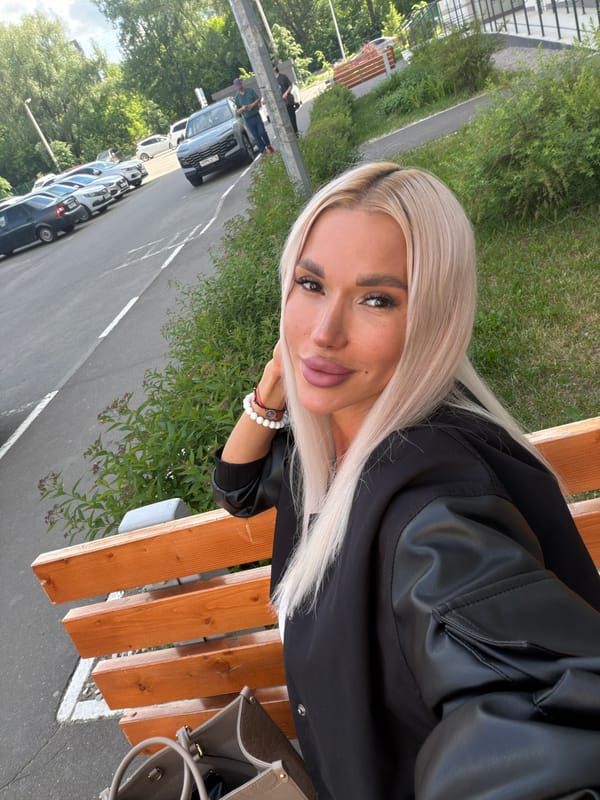 Woman sits on bench in Grebeni urban area