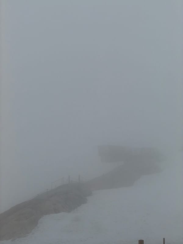 Dense fog shrouds Garmisch-Partenkirchen mountain observation platform, dining areas