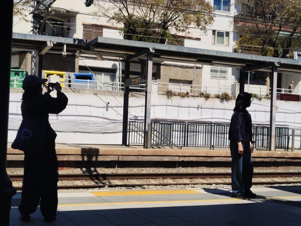 Two people spotted on sunny Sitges train platform