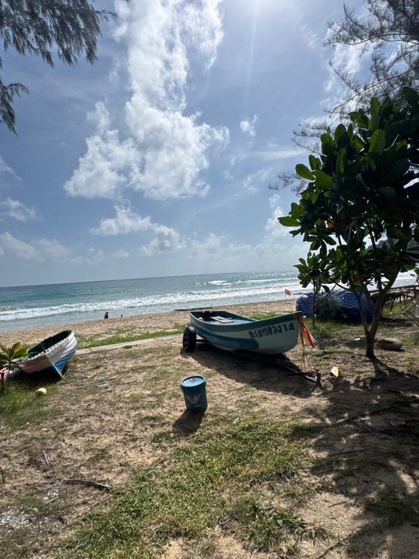 Karon Beach morning: parasailing, shoreline activity, and calm surf