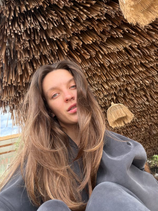 Woman rests on straw bundles in Montenegro village