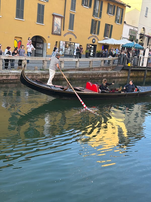 Gondola carries passengers through Milan's Navigli canal district