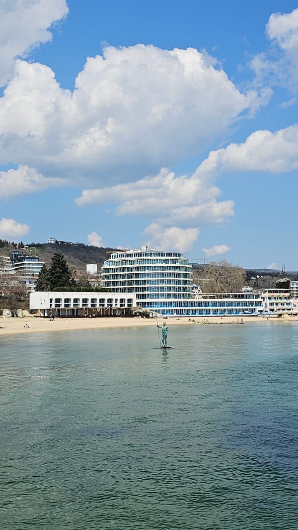 Tourist documents Varna coastline sculptures, dining, buildings during morning visit