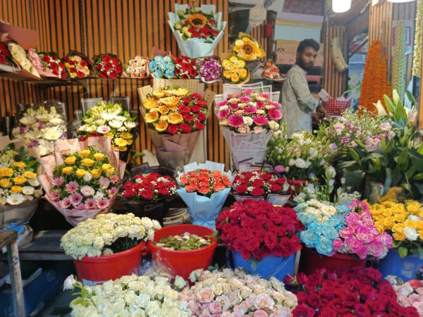 Street vendors and rickshaws captured in downtown Dhaka