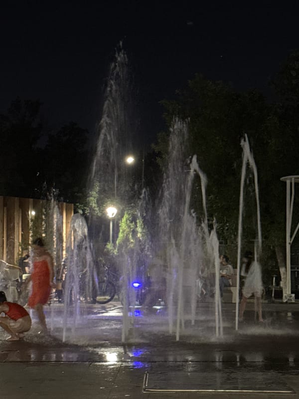 Shymkent park at night: splash pad fun and ride-on toy cars