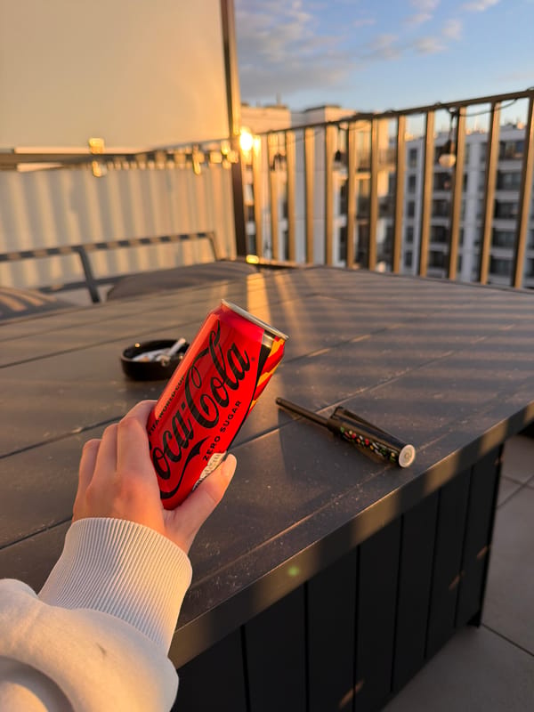Rooftop sunset moment with motorcycle artwork and Coca-Cola