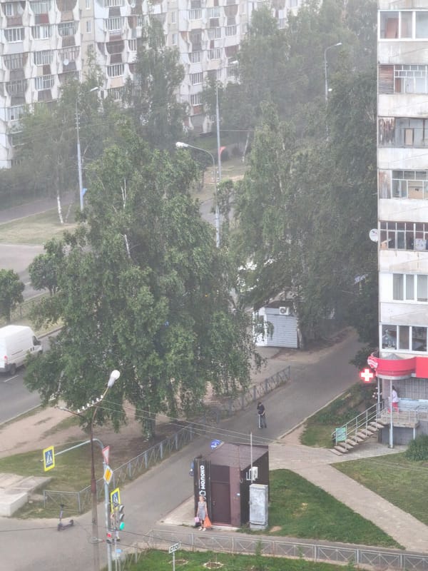 Resident documents rainy afternoon across Yoshkar-Ola apartment districts