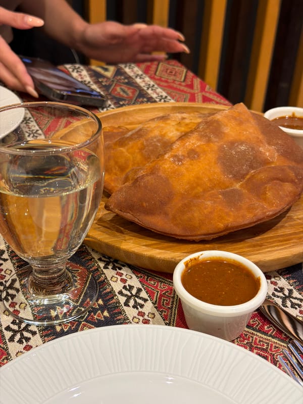 Casual meal gathering in unfinished concrete space, Givatayim