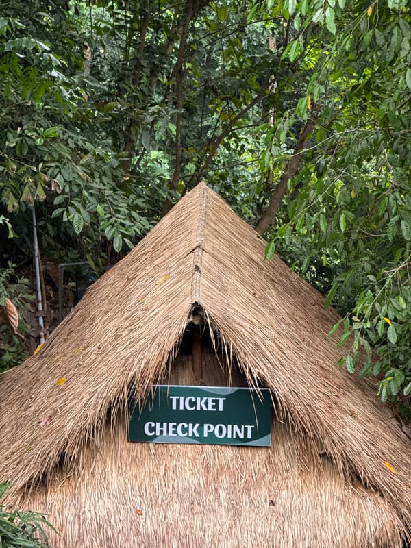 Tourist site with traditional checkpoint and Ogoh-ogoh statue documented