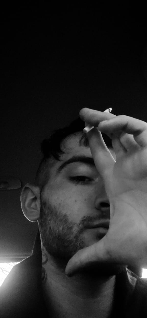 Person photographed smoking in artistic black-and-white shots, Bulgaria