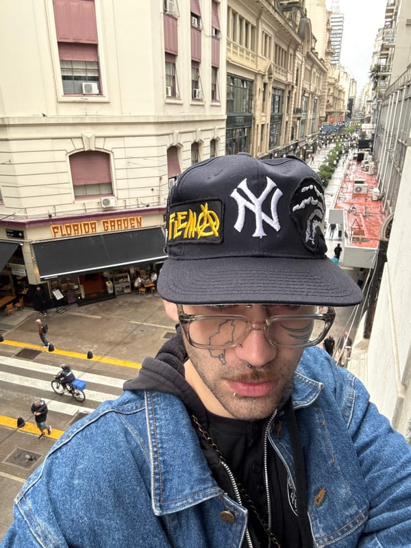 Person in denim jacket observed overlooking Buenos Aires street